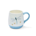 Rounded belly mug with dragonfly and floral illustrations, soft blue handle and matching base.