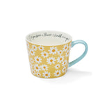 Mug with yellow and white daisy design, soft blue handle and ‘If you were a flower, I would pick you’ message inside.