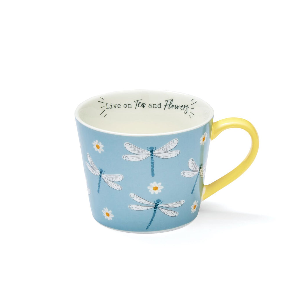 Sky-blue mug with dragonfly and daisy illustrations, yellow handle and interior, and ‘Live on tea and flowers’ message inside.