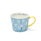 Sky-blue mug with dragonfly and daisy illustrations, yellow handle and interior, and ‘Live on tea and flowers’ message inside.