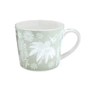 Sage-green mug with white floral and botanical pattern, featuring an oversized flower motif and tapered shape.