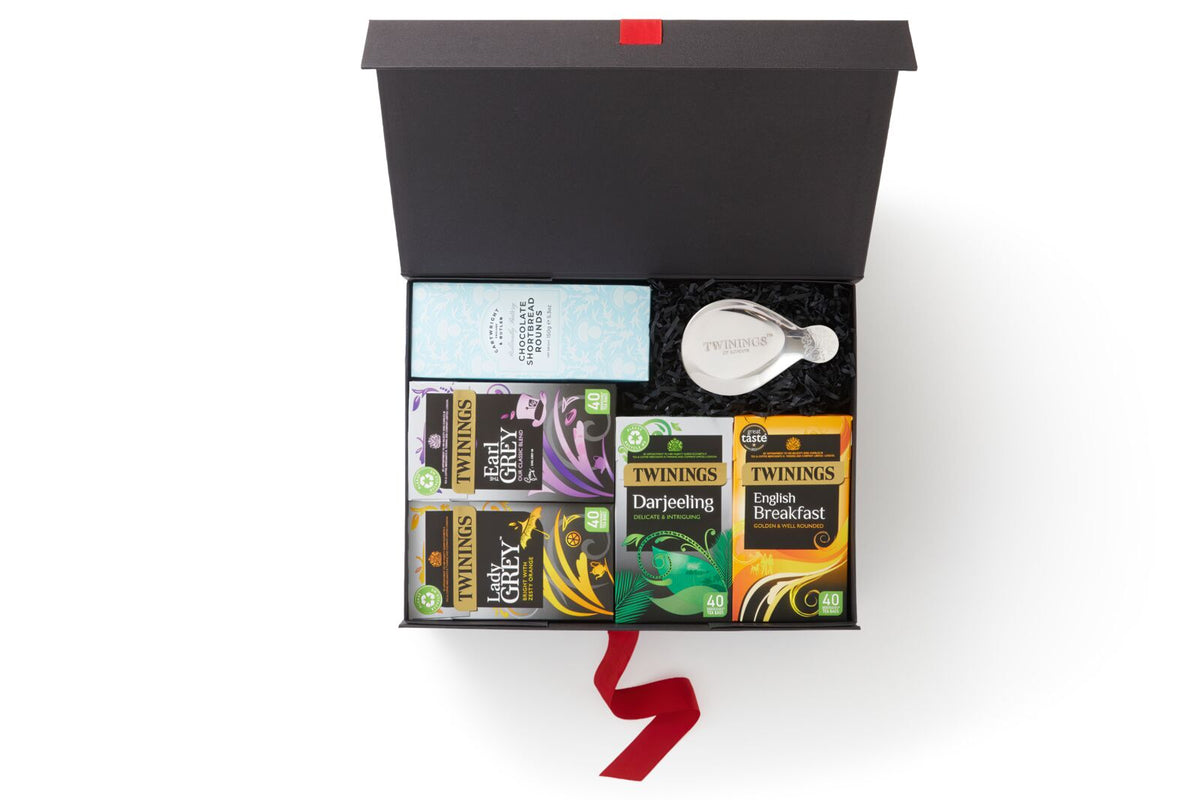 Timeless Black Tea Classic gift box with black tea, tea tidy, and Cartwright & Butler biscuits, inside black and white box with red ribbon 