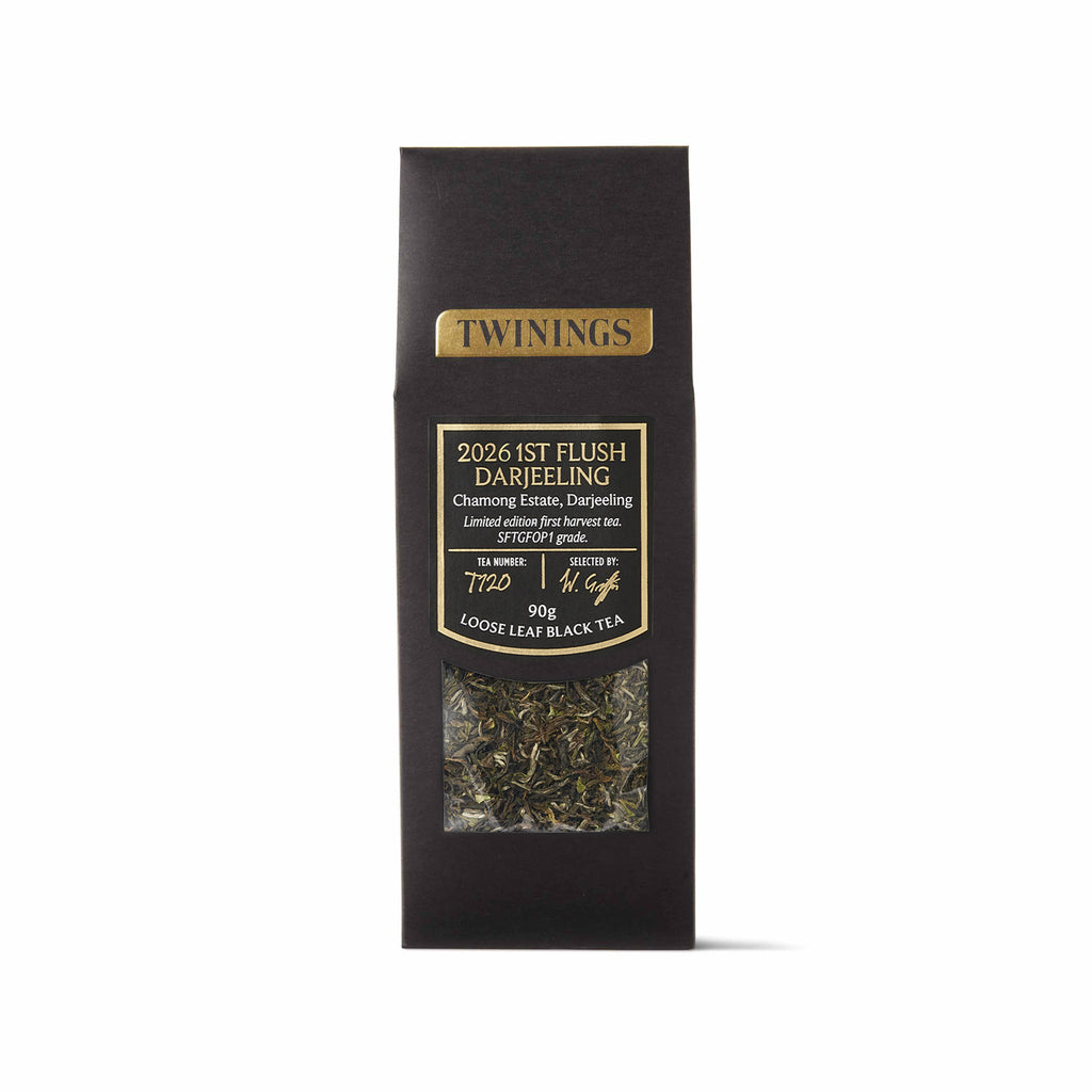 A tall, narrow black tea bag package with gold and white text, featuring a clear window near the bottom that shows loose-leaf black tea. The brand name 'TWININGS' is clearly visible at the top.