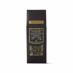 A tall, narrow black tea bag package with gold and white text, featuring a clear window near the bottom that shows loose-leaf black tea. The brand name 'TWININGS' is clearly visible at the top.