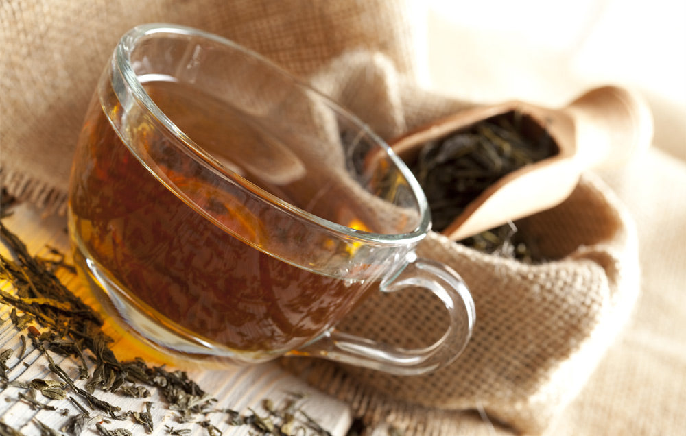 Clear glass mug filled with tea 